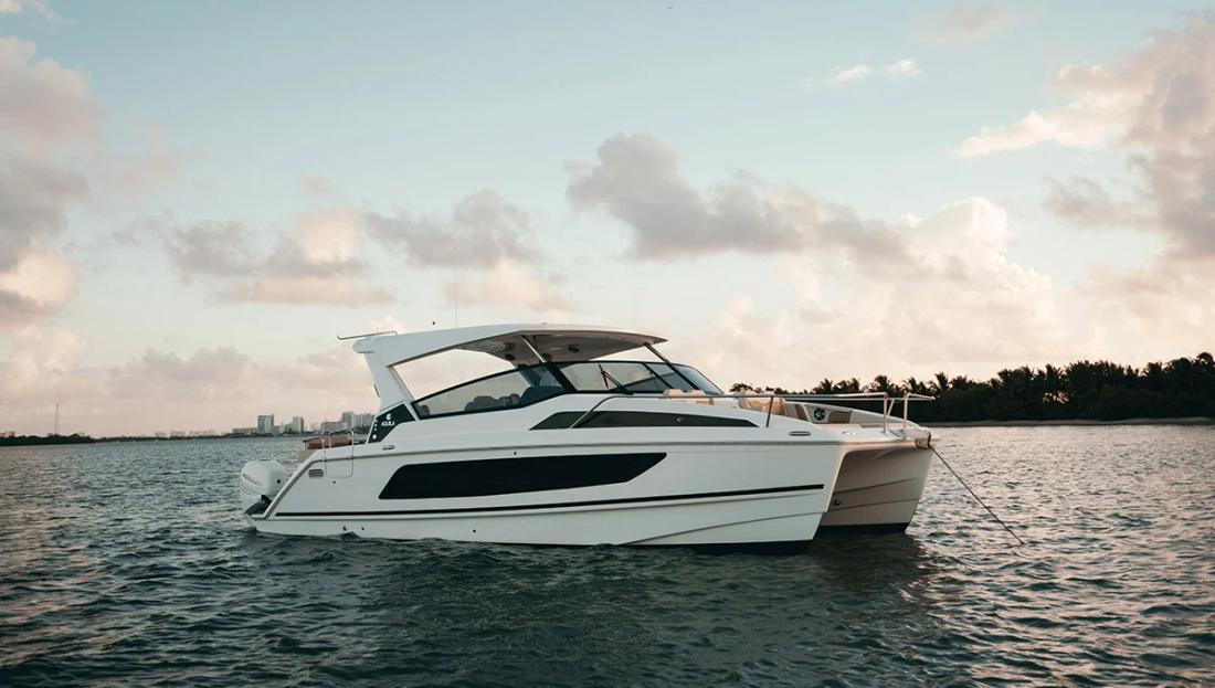 Aquila 36 Sport power catamaran cruising at sunset