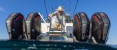 Angler at the transom of the Aquila 47 Molokai between quad Mercury outboards