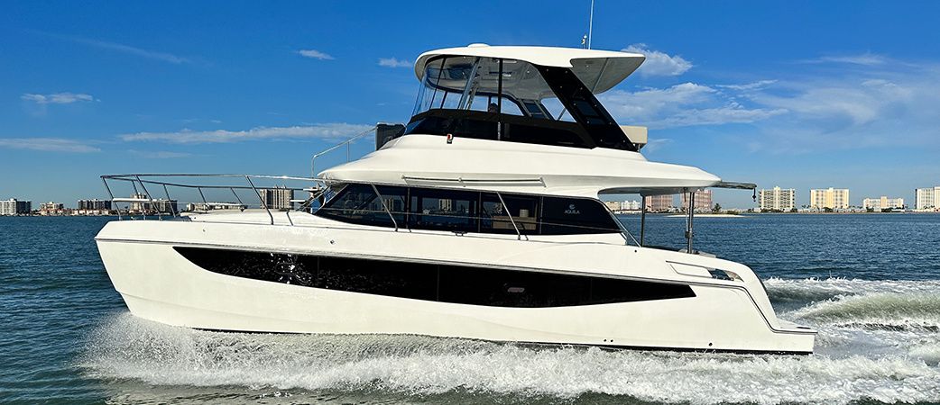 Aquila 42 Yacht flybridge power catamaran running at speed, starboard side view