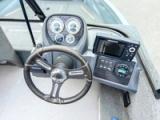 Helm of the Starcraft Storm 16 DC with steering wheel, gauges, fish finder display and switch panel
