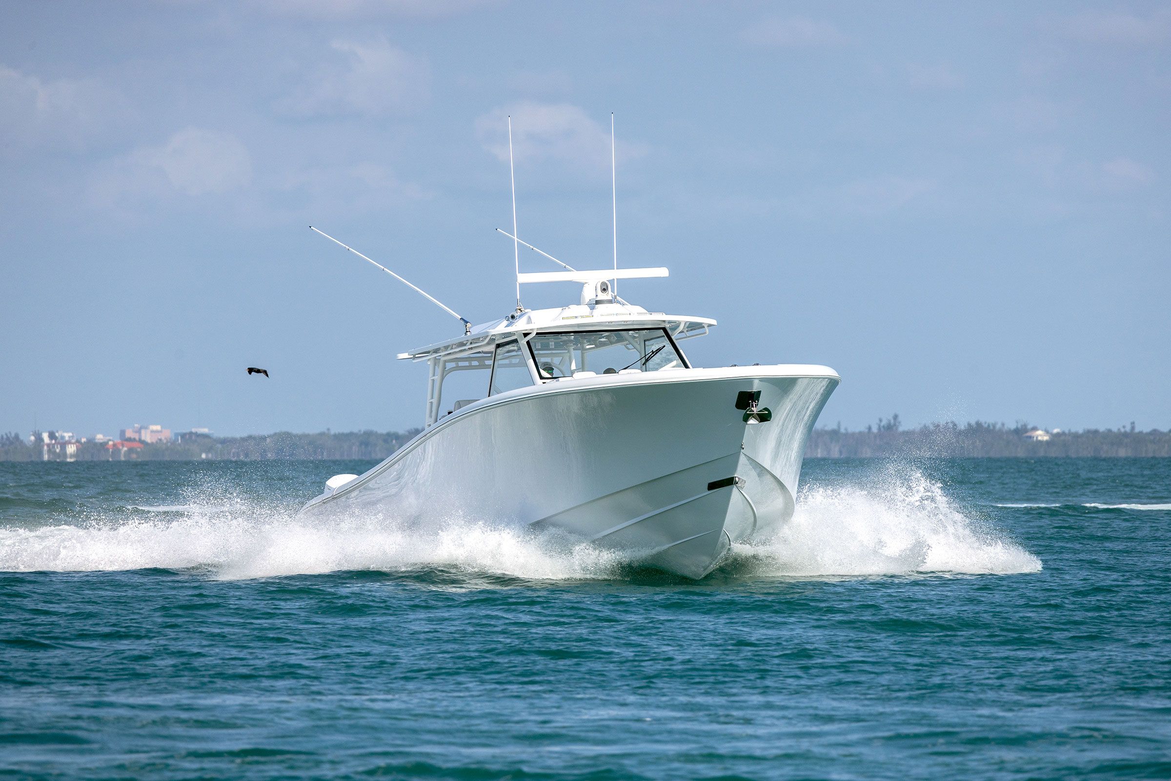 Yellowfin 54 Offshore running at speed, bow-on, with a wide wake and a large hardtop