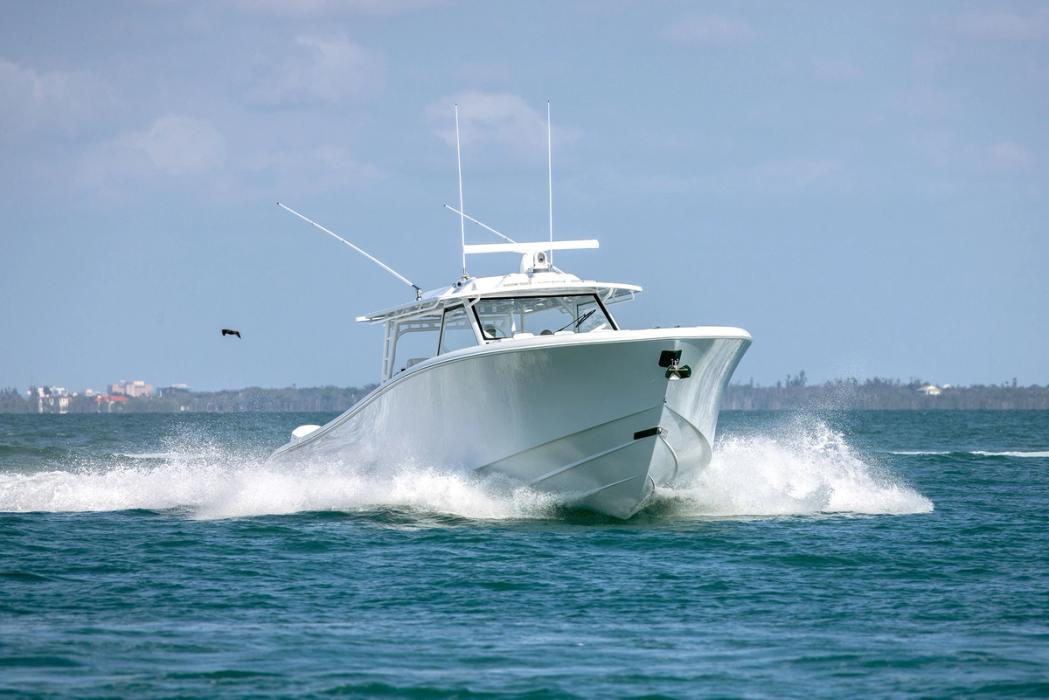 Yellowfin 54 Offshore running at speed, bow-on, with a wide wake and a large hardtop