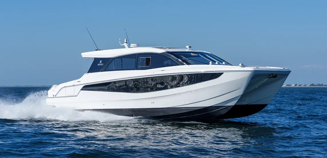 Aquila 46 Coupe power catamaran running at speed in open water, starboard side view