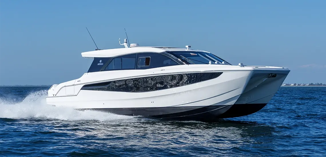 Aquila 46 Coupe power catamaran running at speed in open water, starboard side view