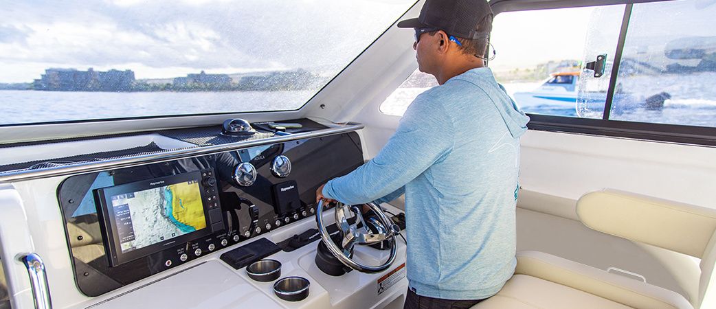 Aquila 28 Molokai Cuddy protected helm station with multifunction display