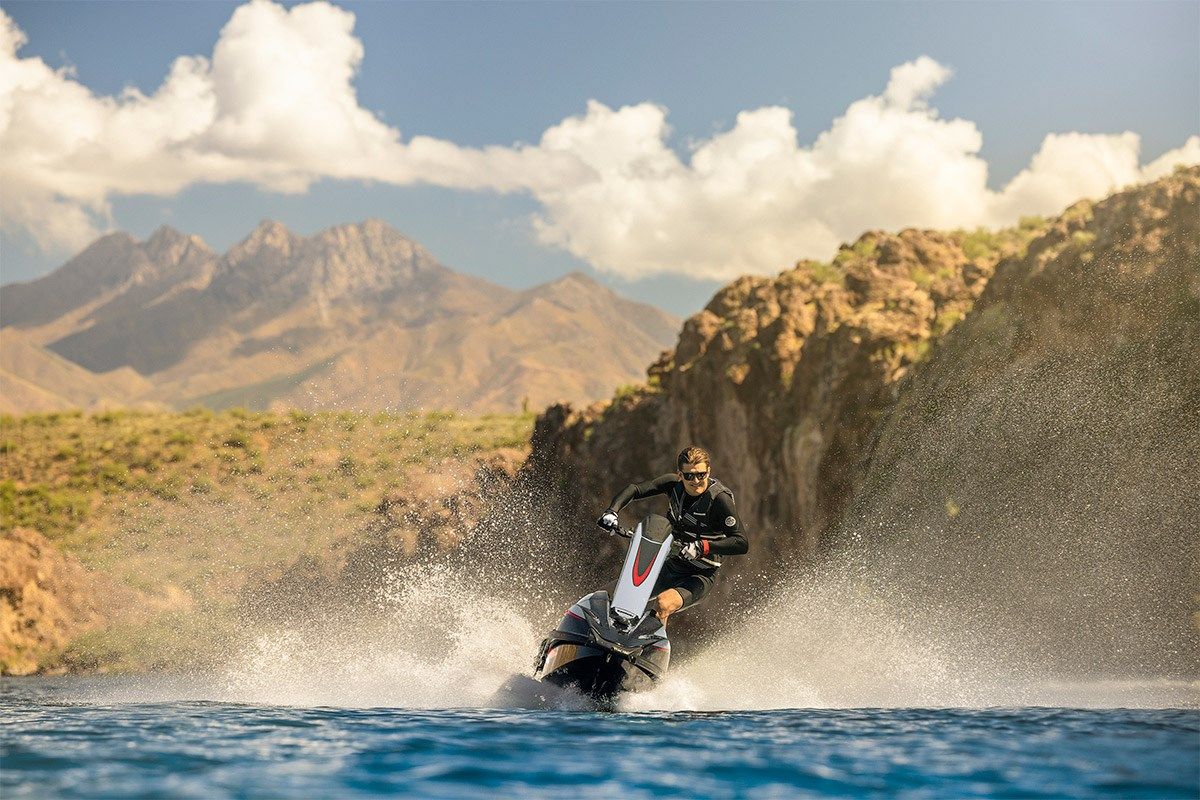 Kawasaki Jet Ski SX-R 160 rider standing on the watercraft, front angle on the water