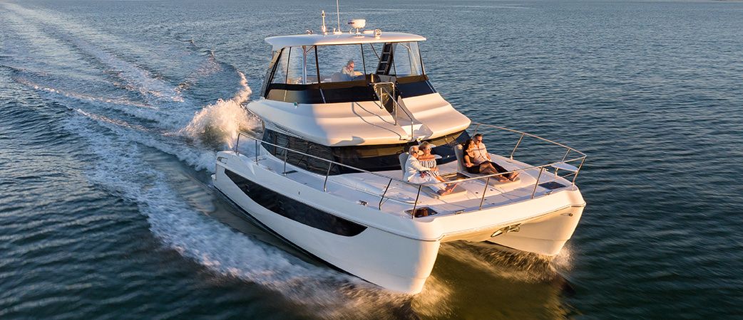 Aquila 42 Yacht underway at speed with guests on the foredeck