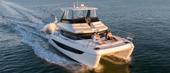 Aquila 42 Yacht underway at speed with guests on the foredeck