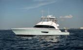 Bertram 61 Convertible starboard profile on open water with anglers in the cockpit