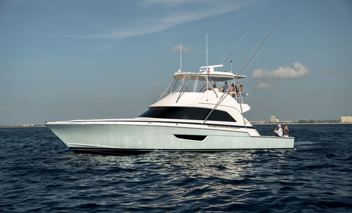 Bertram 61 Convertible starboard profile on open water with anglers in the cockpit