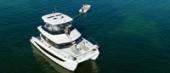 Aerial view of the Aquila 42 Yacht at anchor with its tender
