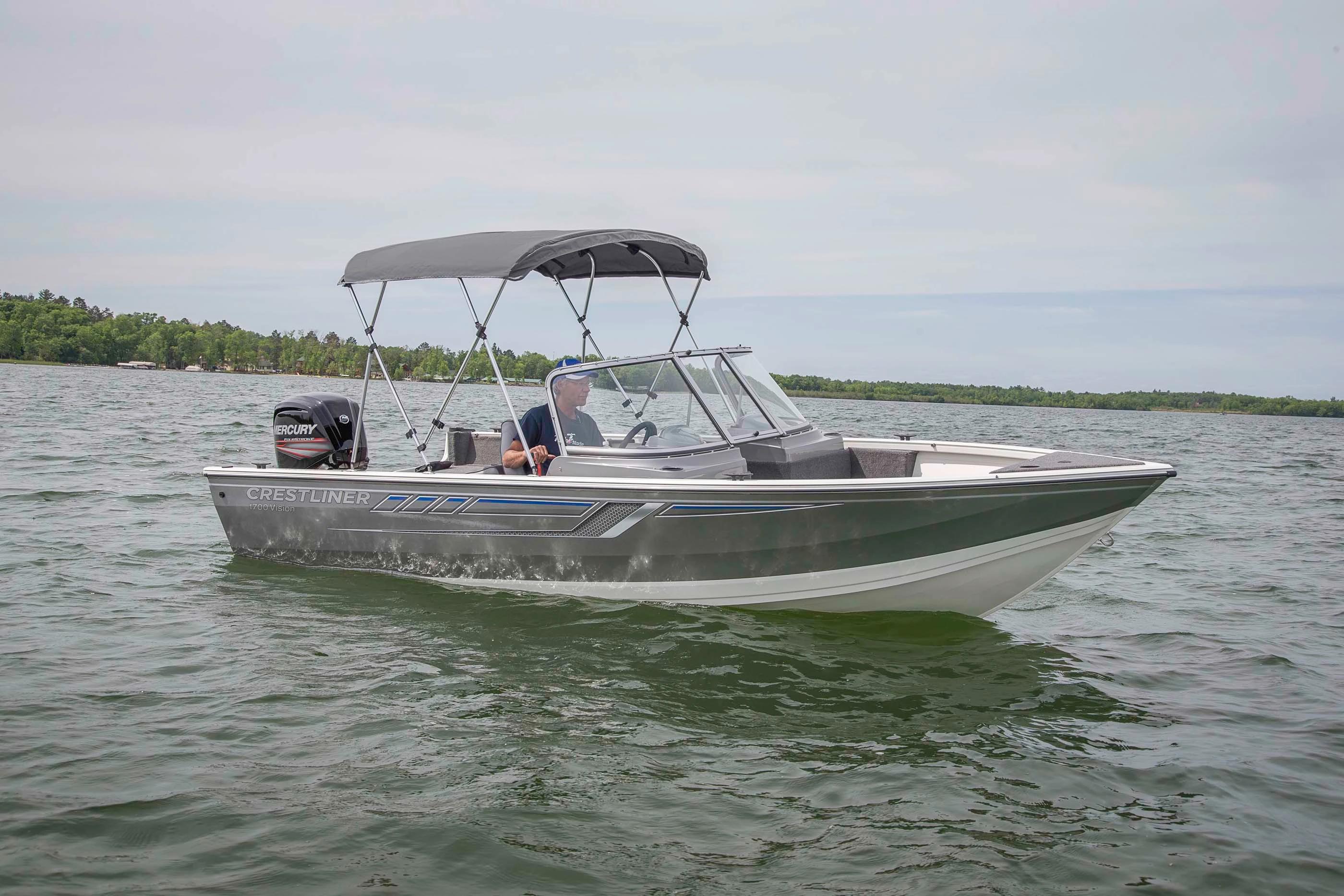 Crestliner 1600 Vision walk-through running with bimini top and outboard