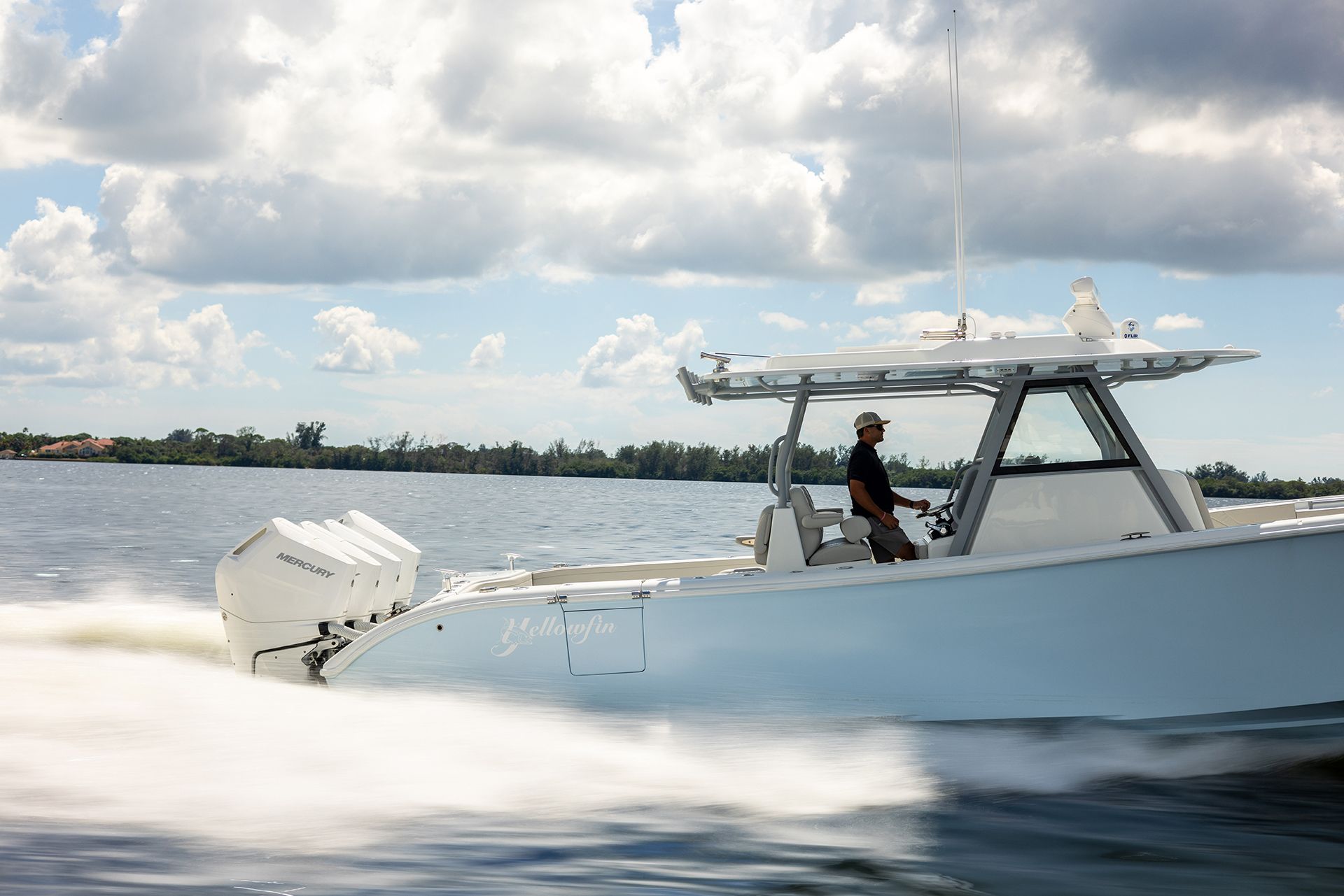 Yellowfin 39 Offshore running at speed, side view, with a hardtop and outboards on the transom