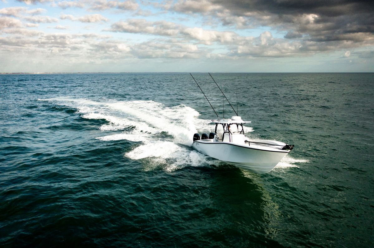 Yellowfin 34 Offshore heading out to sea at sunrise with rod holders on the hardtop