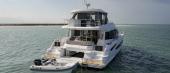 Aquila 54 Yacht from astern, showing transom steps, cockpit and flybridge