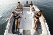 Overhead view of the open bow seating area of a Starcraft SVX 191 OB with passengers relaxing on the cushioned benches