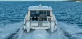 Aquila 46 Coupe from astern, showing twin Mercury Verado outboards and the aft cockpit