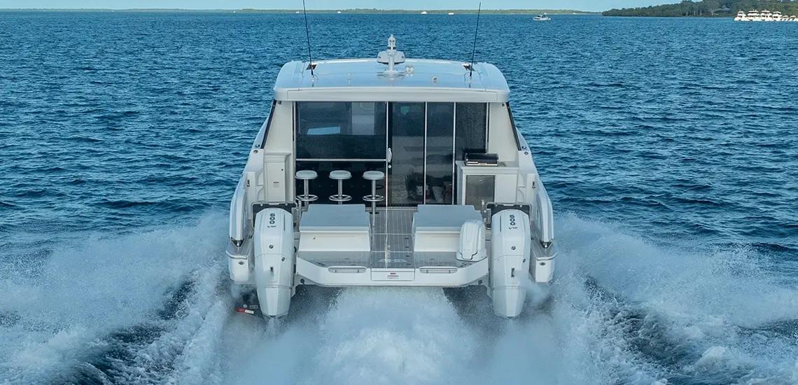 Aquila 46 Coupe from astern, showing twin Mercury Verado outboards and the aft cockpit