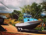 Anderson 22 pilothouse with outriggers on a twin-axle road trailer
