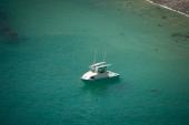 Aerial view of a Greenough 21 pilothouse at anchor in clear green water