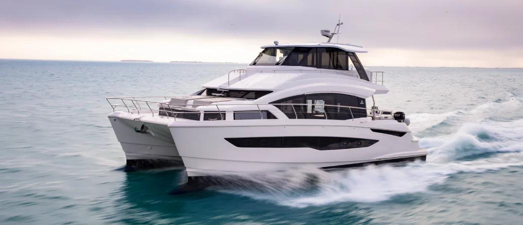 Aquila 54 Yacht flybridge power catamaran running at speed, starboard bow view