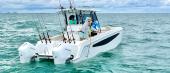 Aquila 28 Molokai from astern with twin outboards and rods in the hardtop rocket launchers