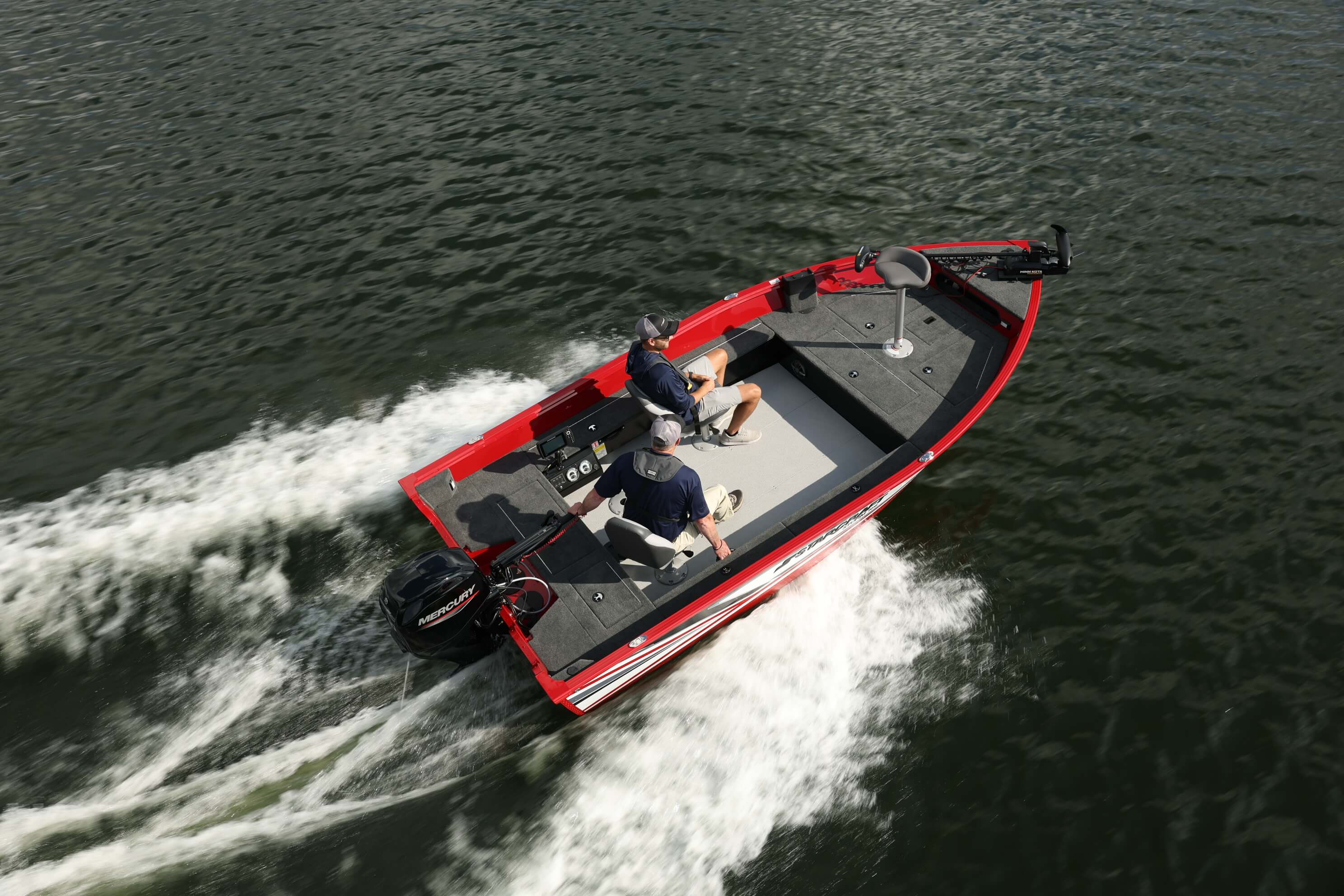 Aerial view of a red Starcraft Storm aluminium fishing boat running at speed with a white wake and anglers on board