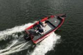 Aerial view of a red Starcraft Storm aluminium fishing boat running at speed with a white wake and anglers on board