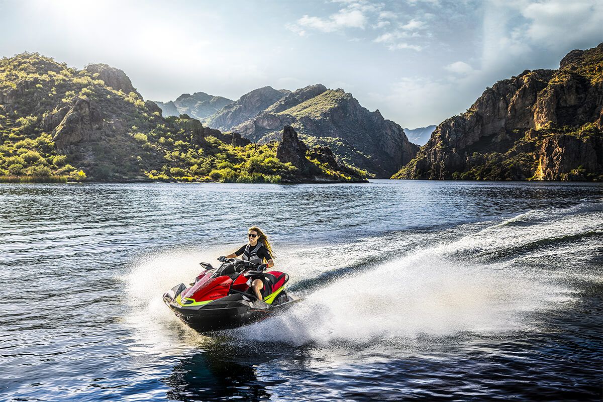 Kawasaki Ultra 310X 2025 jet ski, three-quarter front angle of a rider on a lake