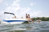 Starcraft SVX 171 OB at anchor on a lake with swimmers in the water and passengers sitting at the stern boarding ladder
