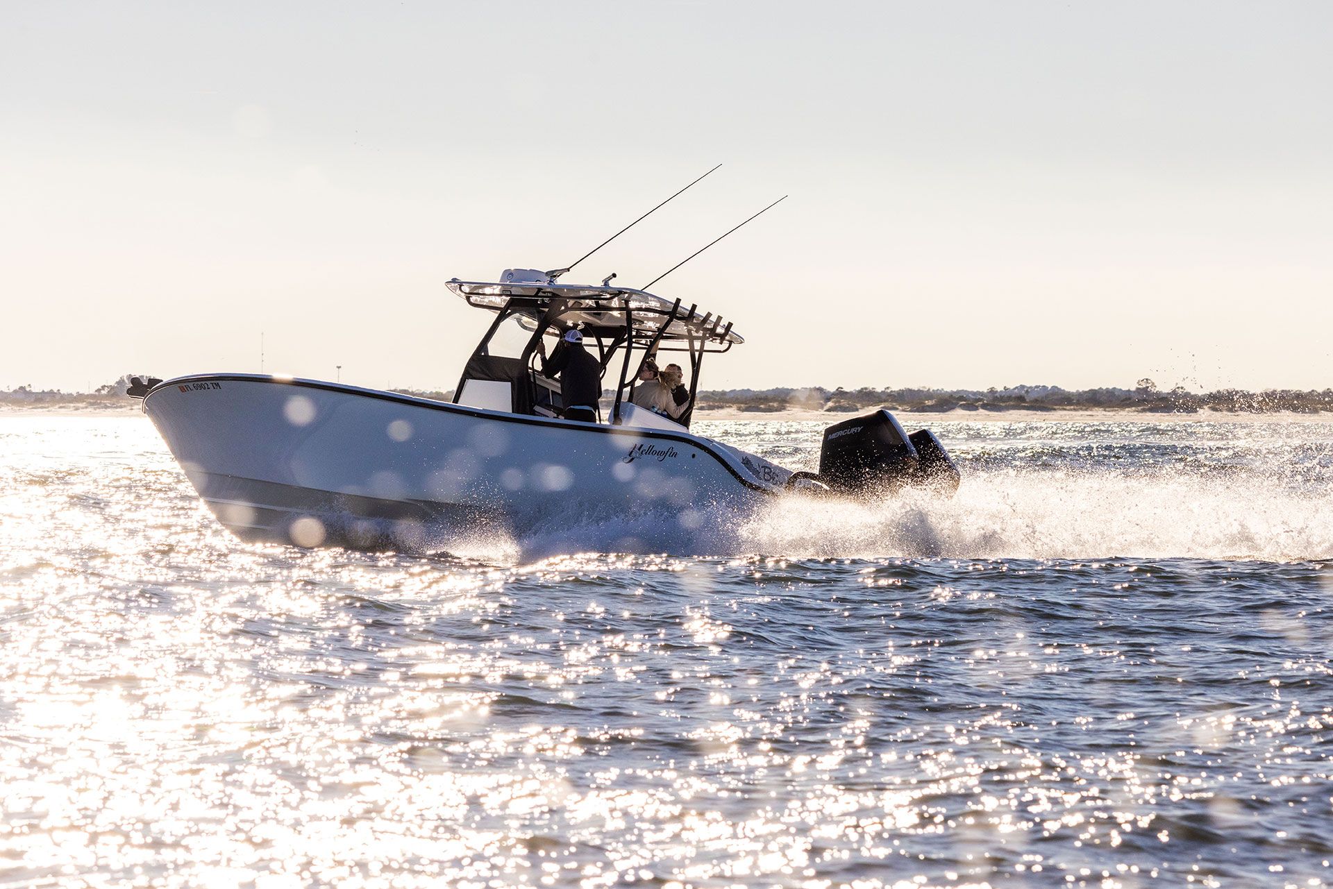 Yellowfin 32 Offshore running in bright sunlight with spray off the hull