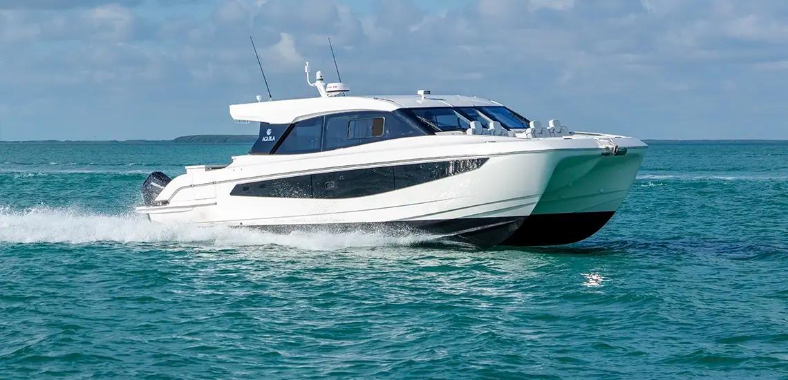Aquila 42 Coupe power catamaran running at speed, starboard side view