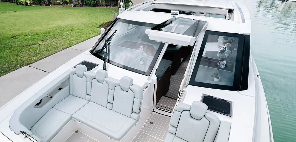 Sheltered bow lounge of the Aquila 46 Coupe with forward-facing seats and opening carbon hatch