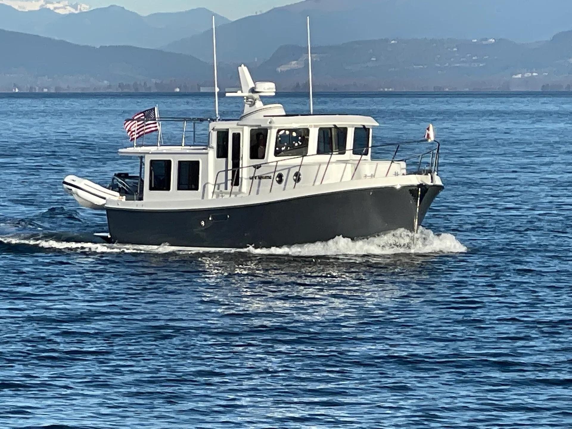American Tug 362 cruising with tender on the stern