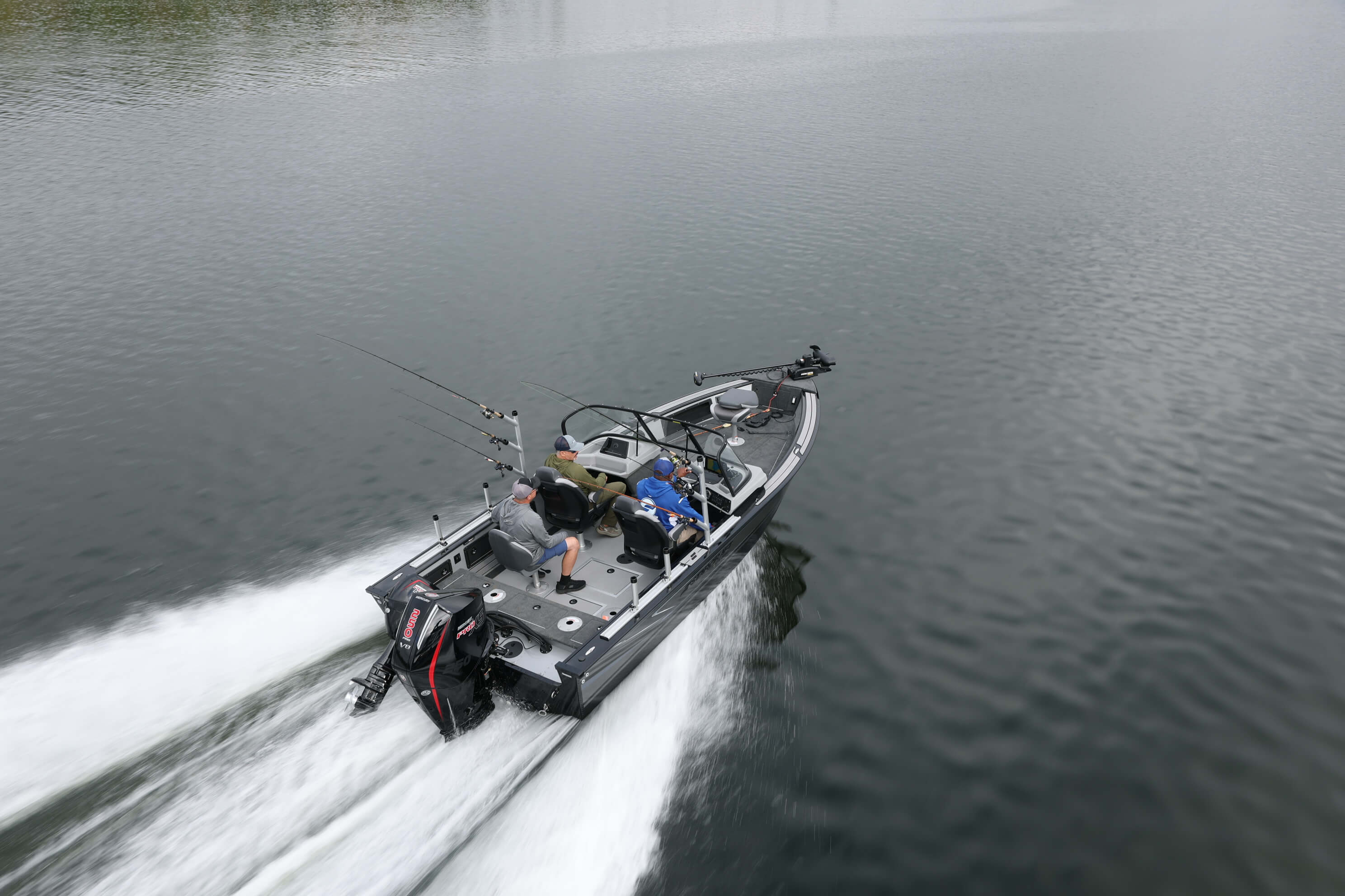 Aerial view from behind of a Starcraft STX 2050 under power, showing the open deck and outboard motor