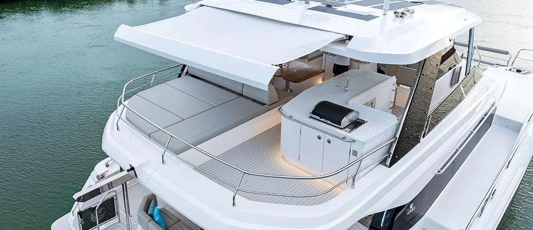 Aquila 50 Yacht flybridge under the hardtop with seating and wet bar