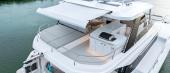 Aquila 50 Yacht flybridge under the hardtop with seating and wet bar