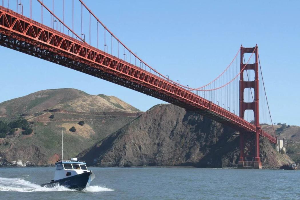 Greenough 21 pilothouse running beneath the Golden Gate Bridge