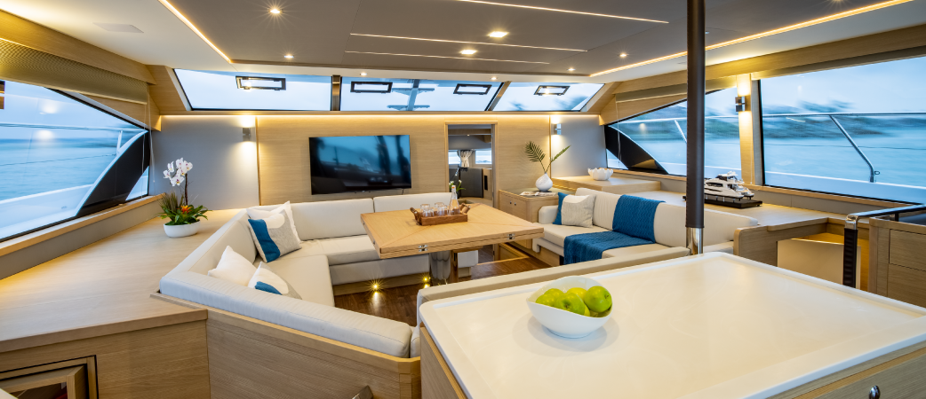 Aquila 54 Yacht panoramic salon with U-shaped seating and dining table