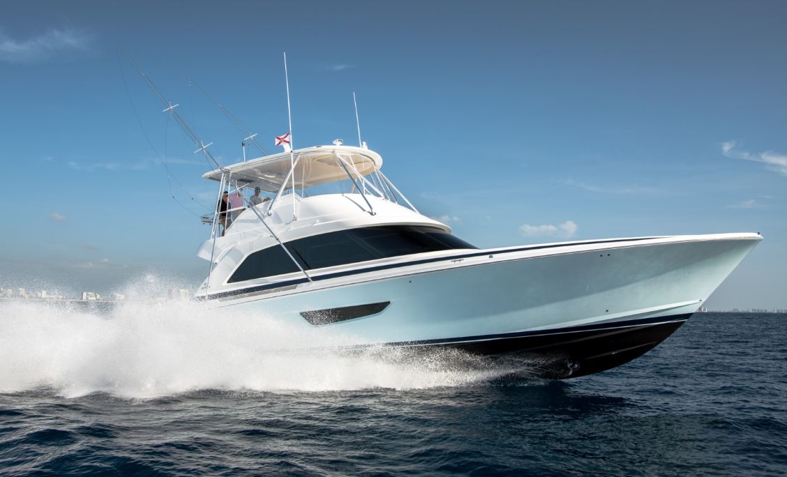 Bertram 61 Convertible running at speed with flybridge hardtop and outriggers