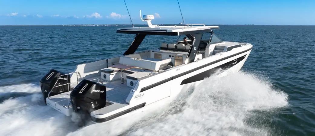 Aerial view of the Aquila 45 Sport running at speed with a long white wake