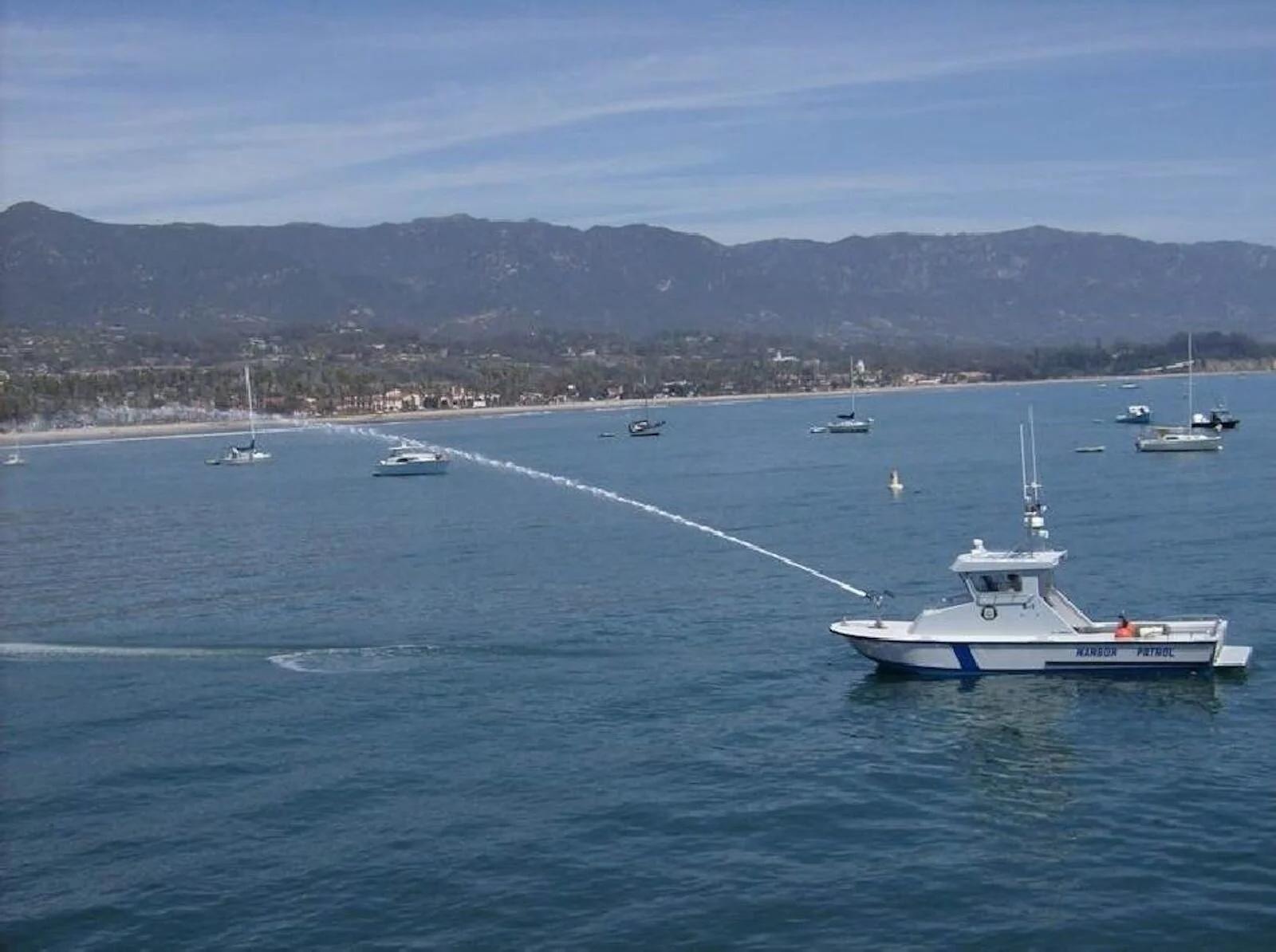 Anderson 31 harbour patrol fire boat spraying a water cannon in a bay