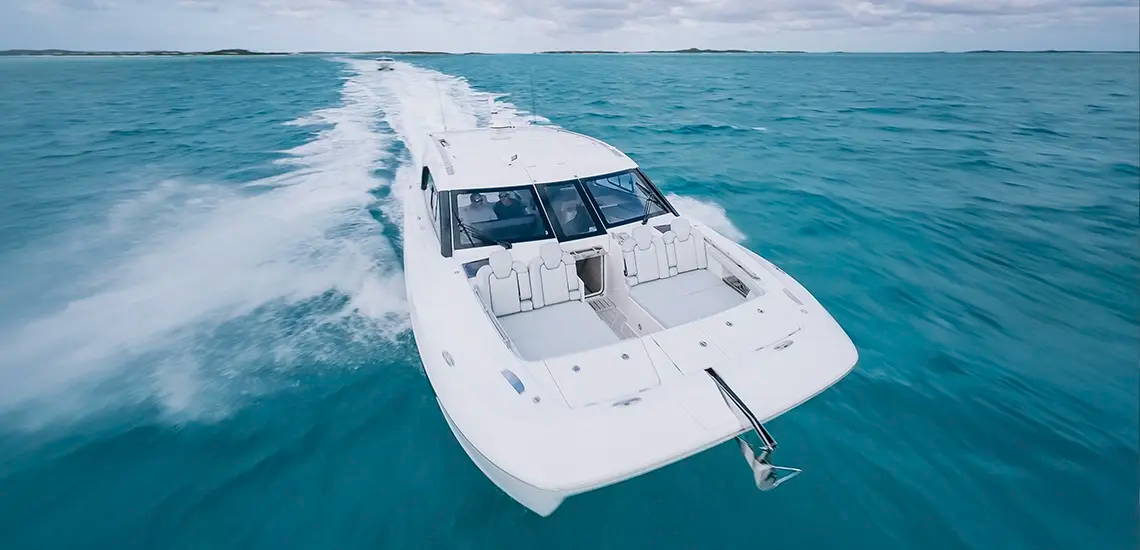 Aerial view of the Aquila 42 Coupe running fast, showing the bow lounge and hardtop
