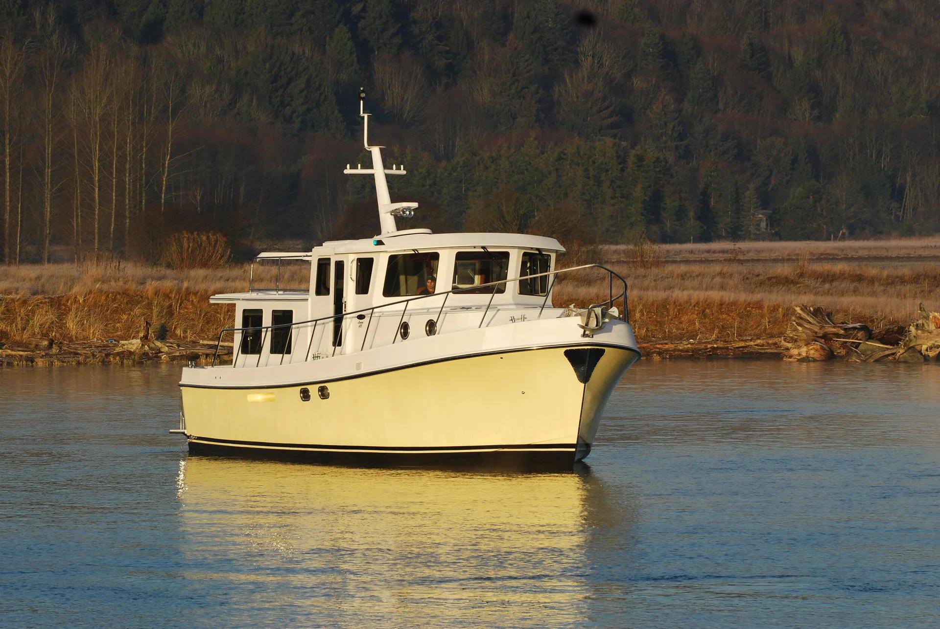 Cream-hulled American Tug 435 at rest on calm water