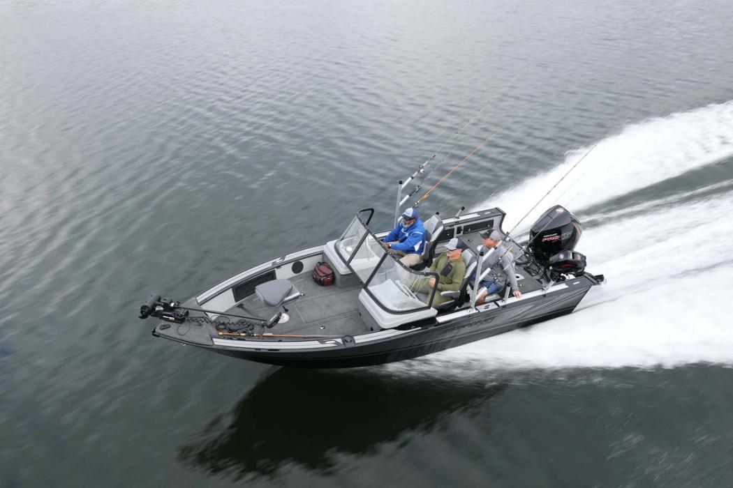 Starcraft STX 2050 aluminium fishing boat with an outboard motor running at speed on calm water, seen from the side and above