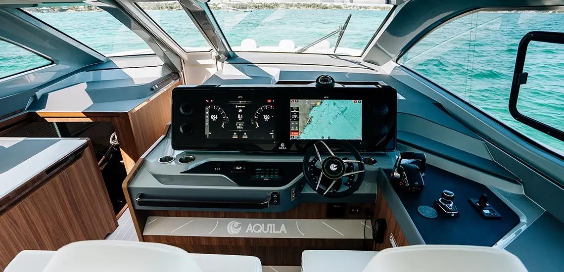 Aquila 46 Coupe helm station with twin displays, steering wheel and joystick