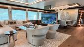 Westport 135 main-deck salon with sectional sofa, armchairs and a lift-up television