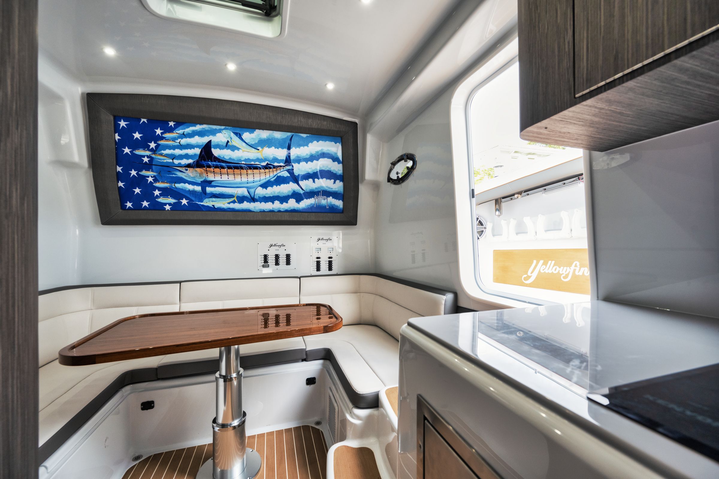 Air-conditioned cabin of the Yellowfin 54 Offshore with a wraparound dinette and galley