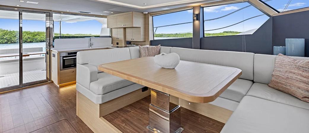 Aquila 50 Yacht salon with U-shaped seating and panoramic windows