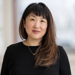 Woman with long dark hair wearing a black top